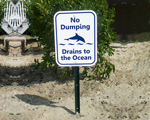 Drains to ocean sign