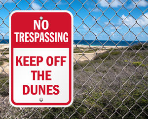 No trespassing keep off dunes sign