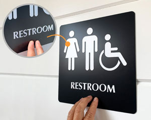 Restoom sign with braille