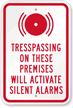 Trespassing On These Premises Will Activate Alarm Sign