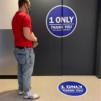 An elevator floor sign and an elevator door sign