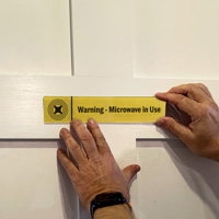 Warning: Microwave in Use Sign on a Door