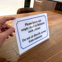 Do not sit across from someone table top sign
