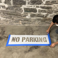 Taping around a no parking stencil